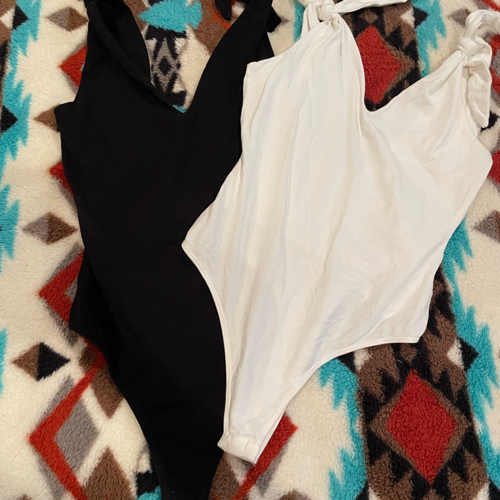 Set of two white and black thong bodysuits